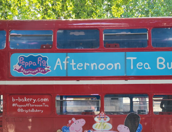 Red Double Decker Bus with "Afternoon Tea Bus Tour" Banner and Peppa Pig Logo